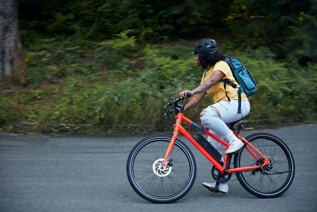 Person riding red RadMission e-bike